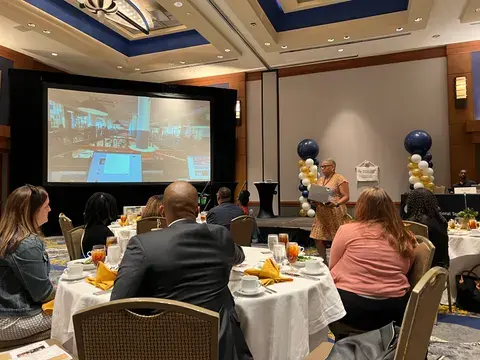 Founders and guests gathered around tables at a startup event